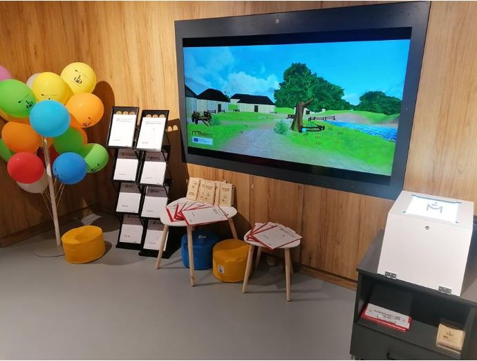 The kids corner set up at lebork museum consists of a large screen, a dispenser of sheets printed with the silhouettes and the draw alive box